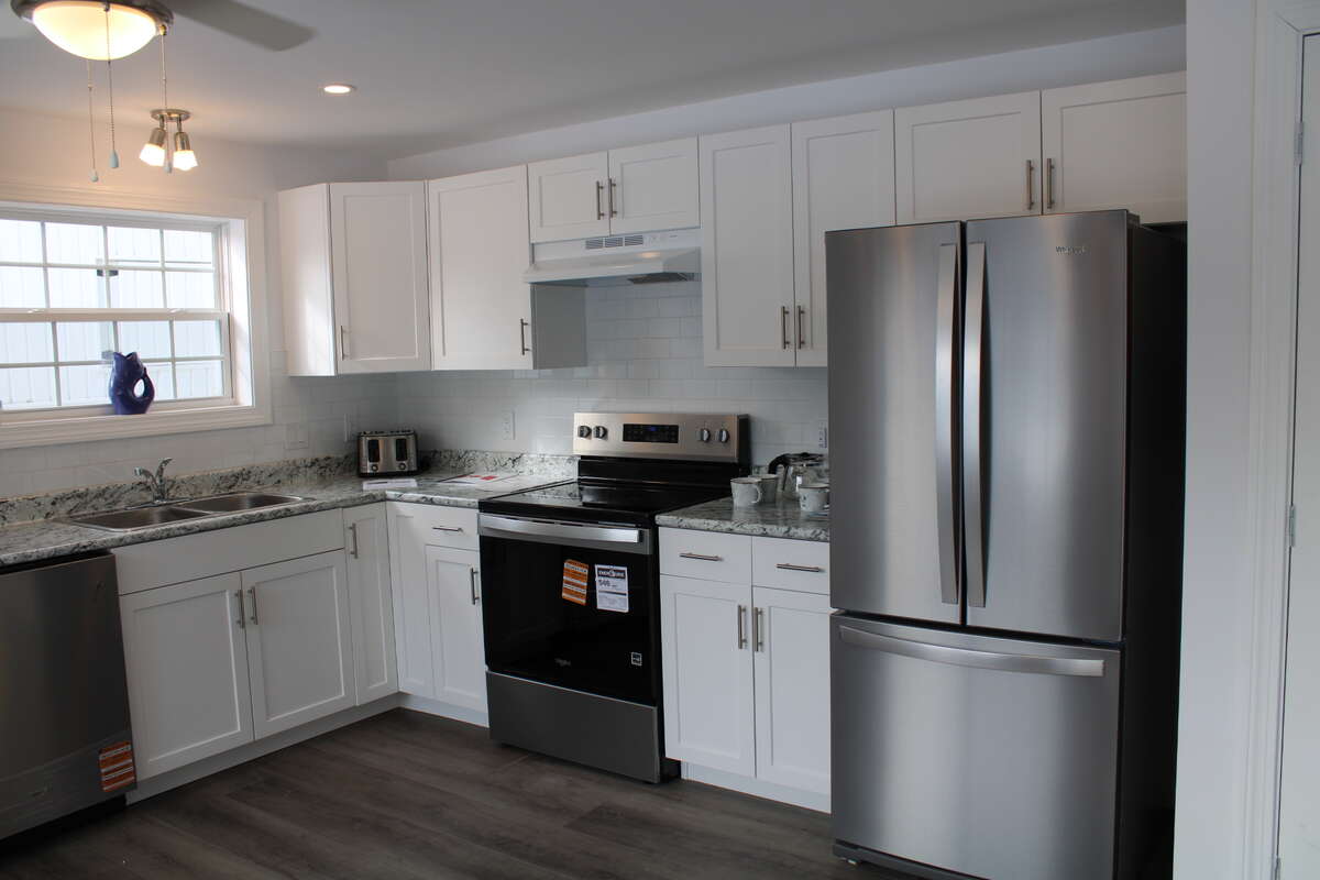 Includes a Whirlpool dishwasher (left), electric range, and French door Fridge with bottom freezer