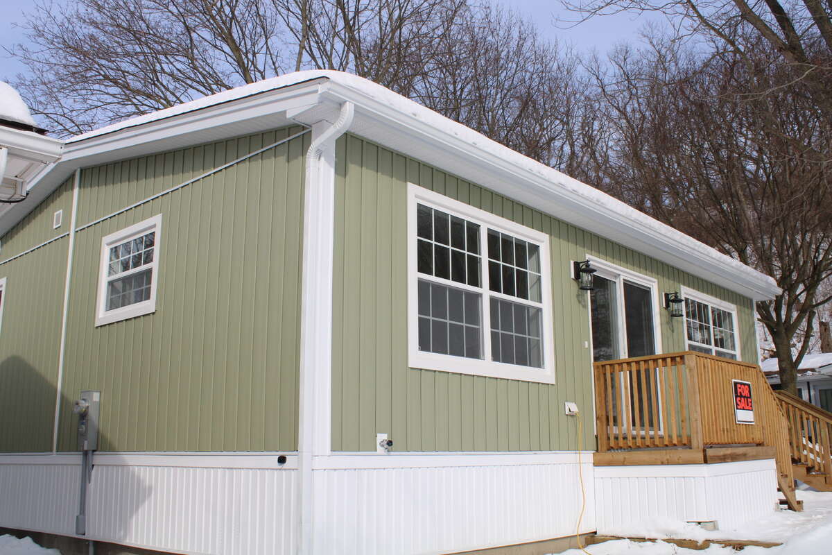 Unit 472 south and west side of the home with windows into the kitchen and patio door