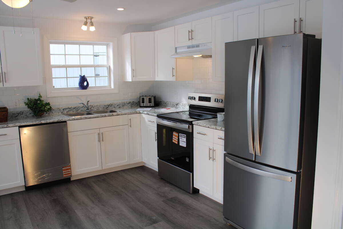 Includes a Whirlpool dishwasher (left), electric range, and French door Fridge with bottom freezer