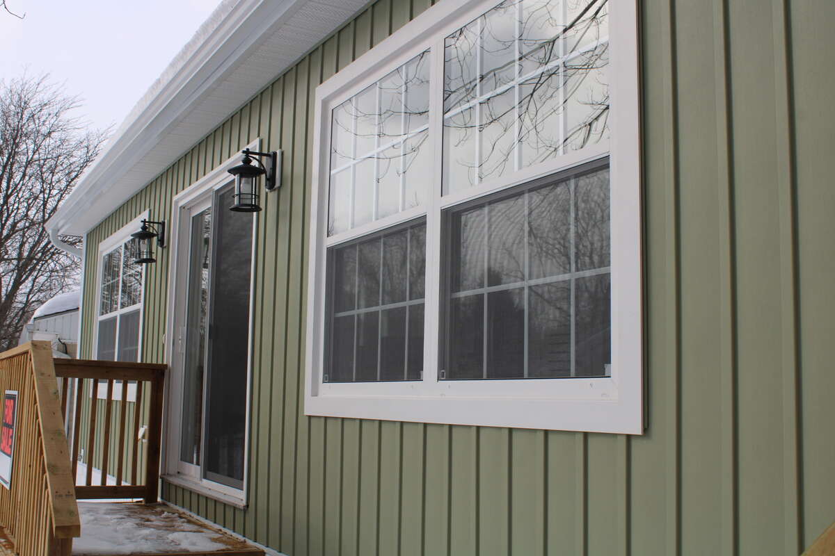 South side with patio door and windows into the living room
