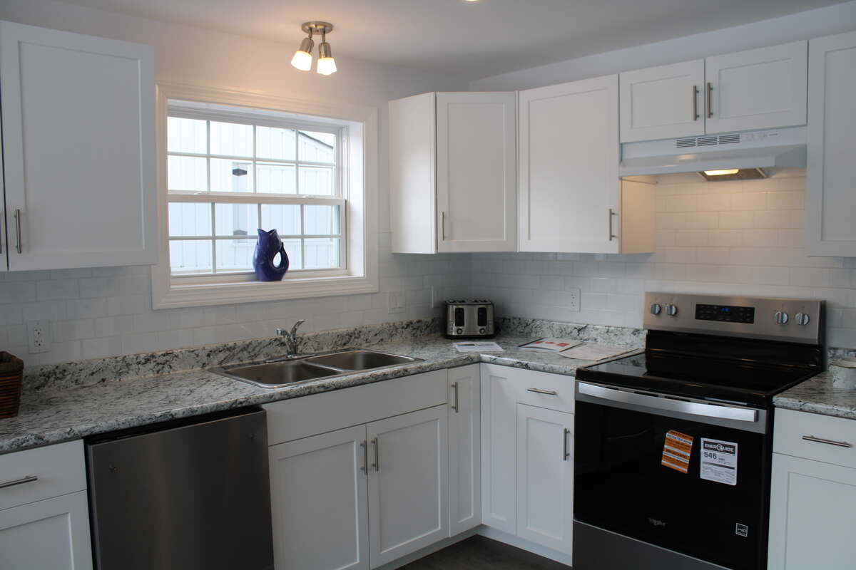 Includes a Whirlpool dishwasher (left), electric range, and French door Fridge with bottom freezer