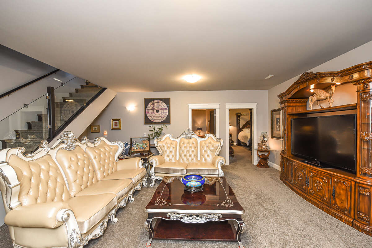 Lower Level Living Area with Home Theatre and Bedroom Entrance View