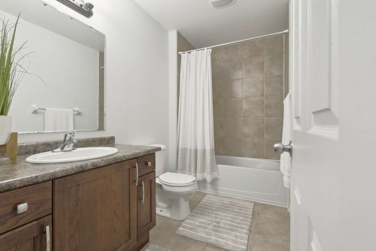 Main bath with tub and ceramic tiles