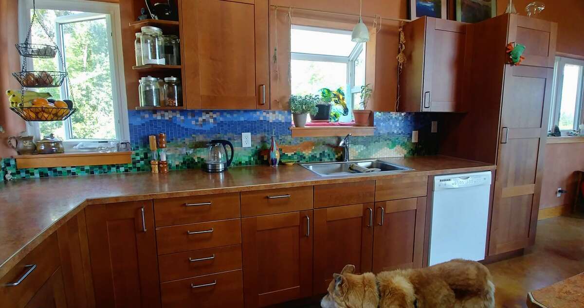 There is a greenhouse window over the sink.