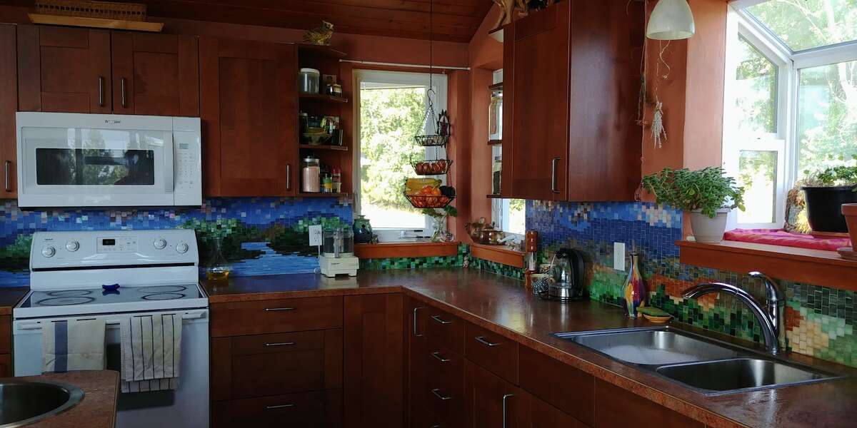 The kitchen with the custom backsplash.  You can get a glimpse of the wood ceiling.