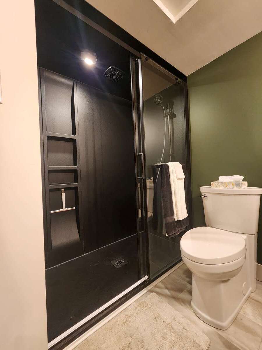 Updated 3pc lower bathroom with modern shower and rainhead showerheads.