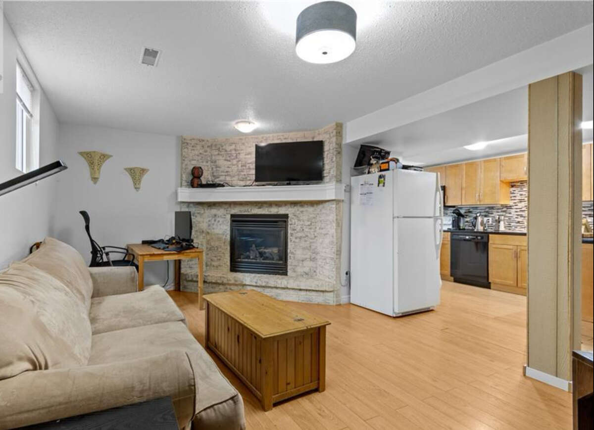 Apartment living room with kitchen in background