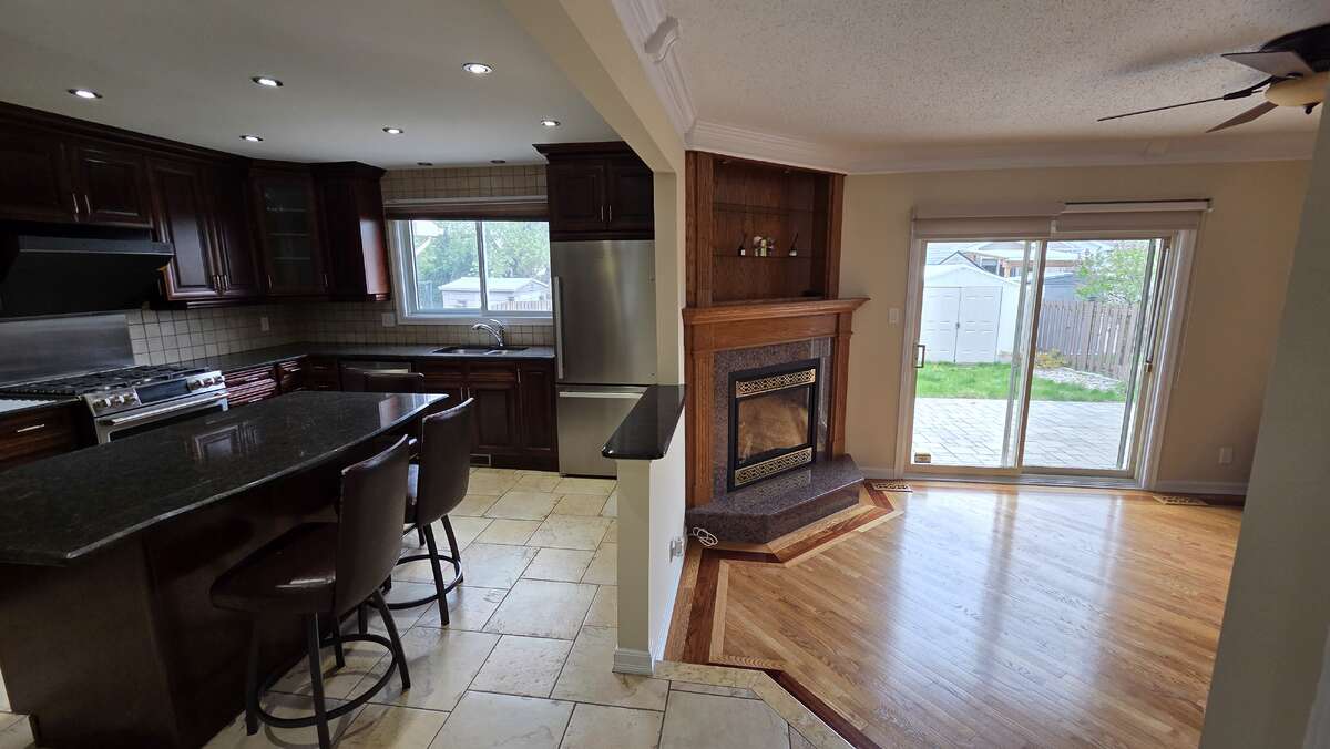 Open-concept kitchen flowing into the cozy family room