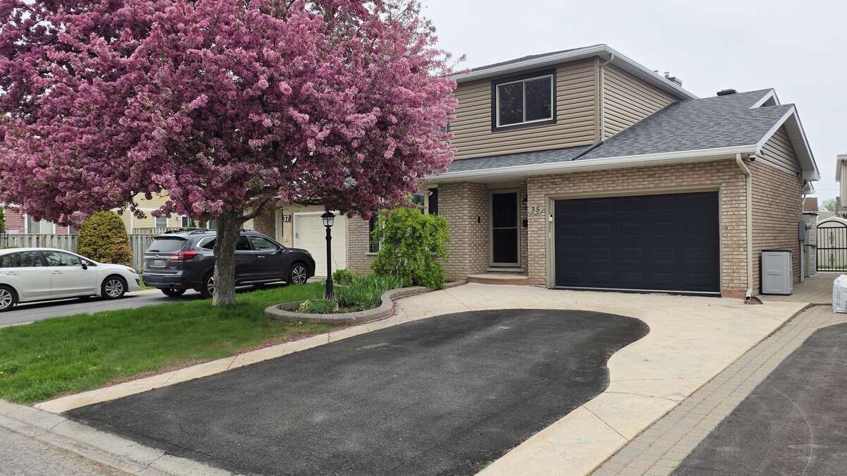 Two-story brick-and-siding home with private double driveway