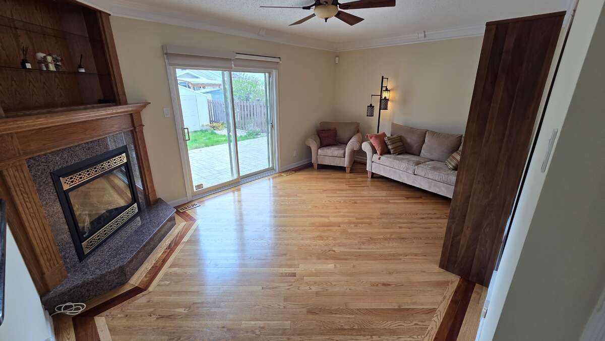 Inviting family room with corner gas fireplace and patio access