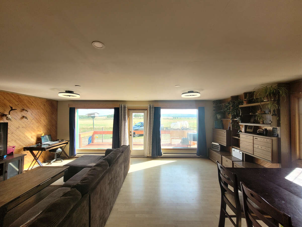 huge double windows and door with access to deck overlooking the fields and rolling hills