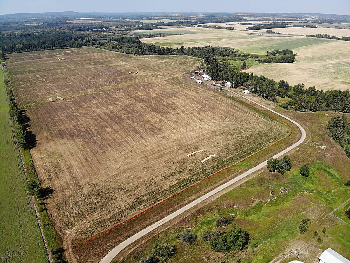hay field, home and treed lot in back, 147 acres