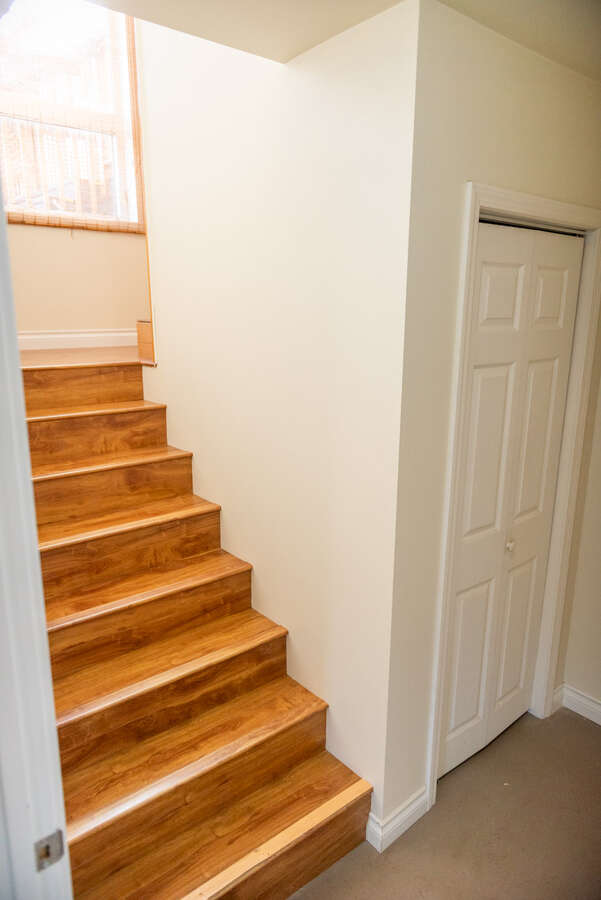 Shared mudroom entrance with a side storage room and laundry machines.