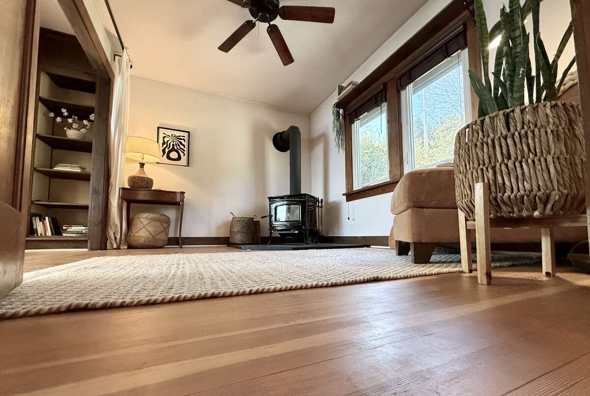View into the den with cozy woodstove.