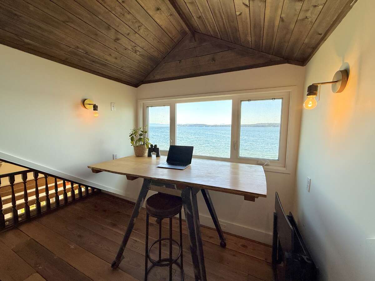 The primary loft bedroom also has a desk/creative nook.