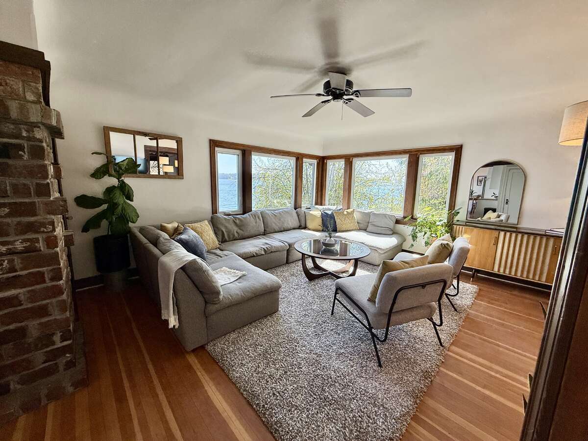 Living room with re-finished original fir floors and character brick.