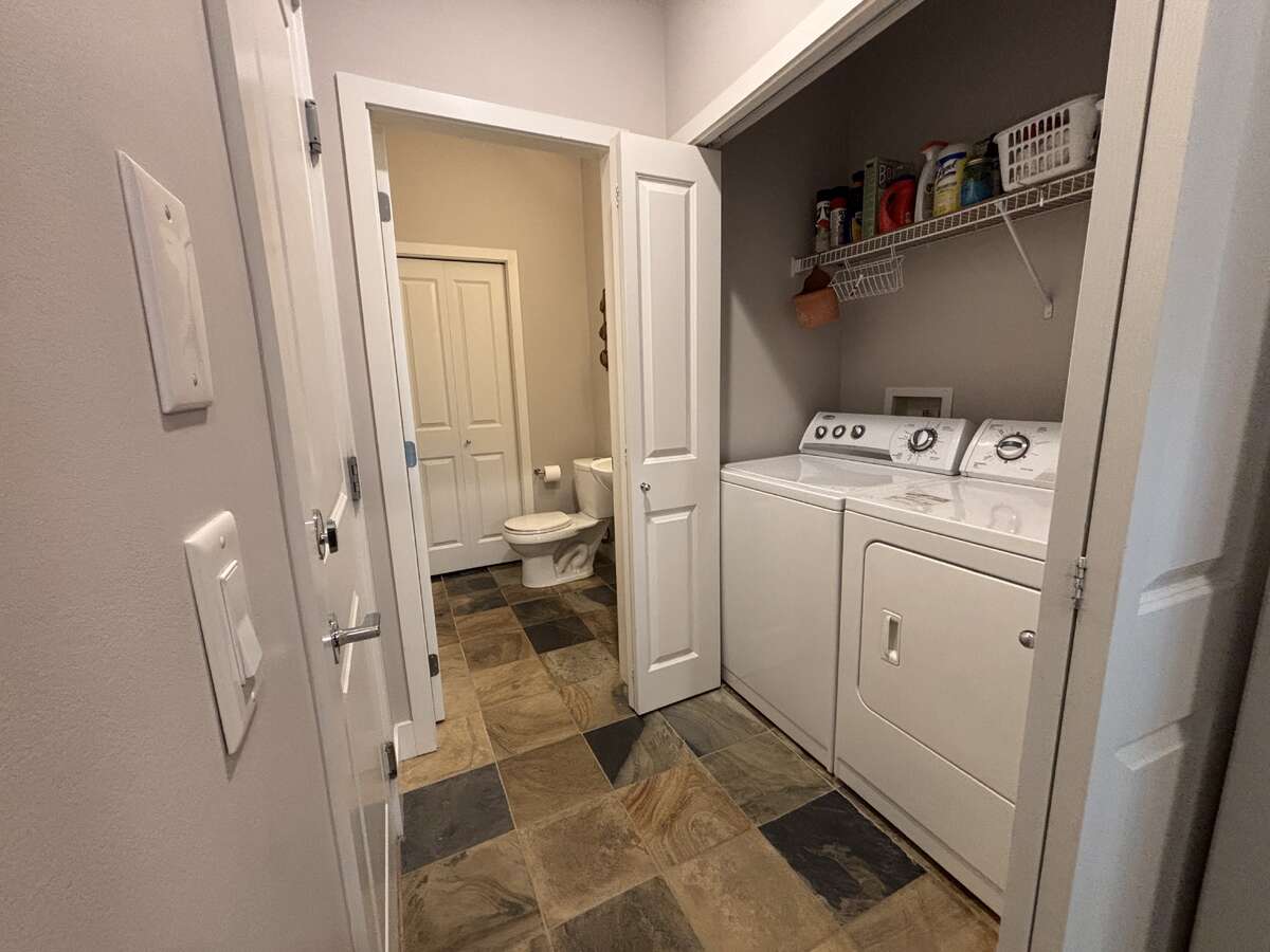 Main Floor laundry with adjacent powder room & utility spadce