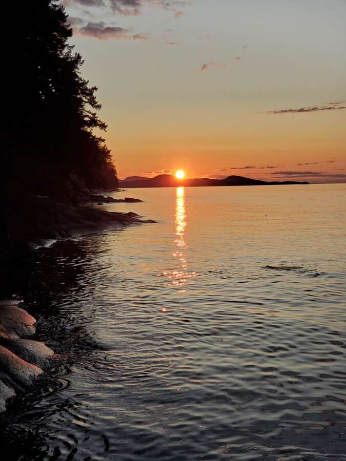 Sunset at low tide on beach.