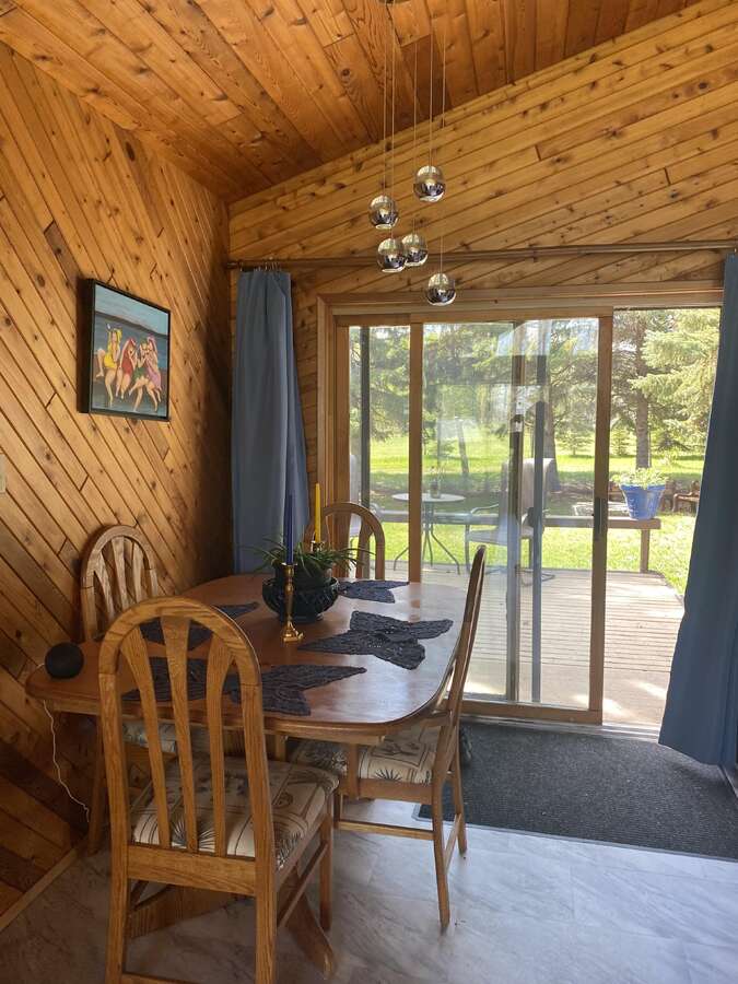 Dinning table in front of sliding glass doors