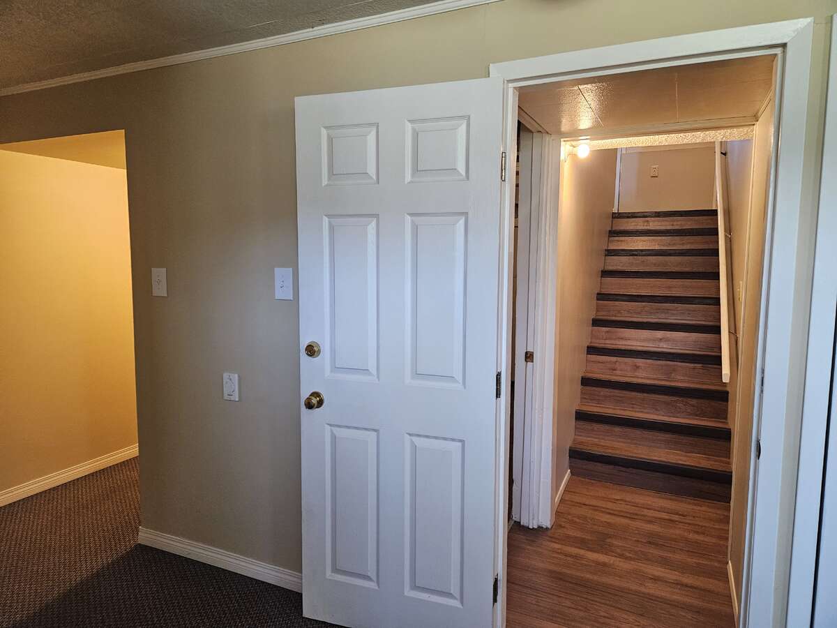 basement stairwell and hall to basement kitchen