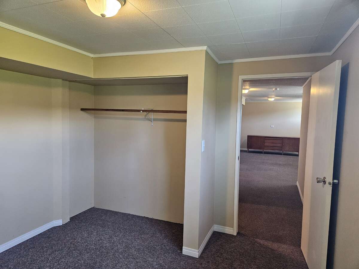 South basement bed by kitchen