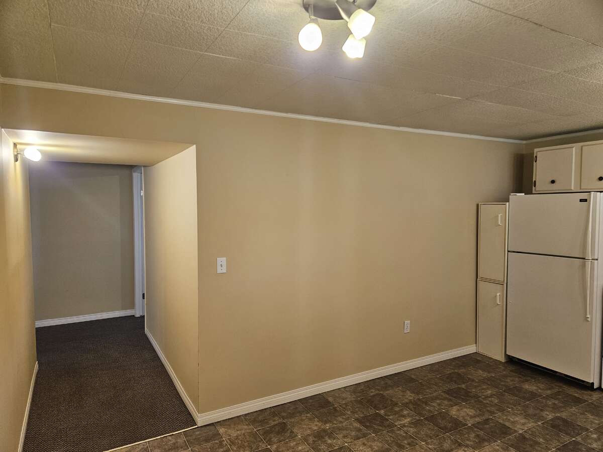 looking from basement kitchen to 1st bed to the right end of hall