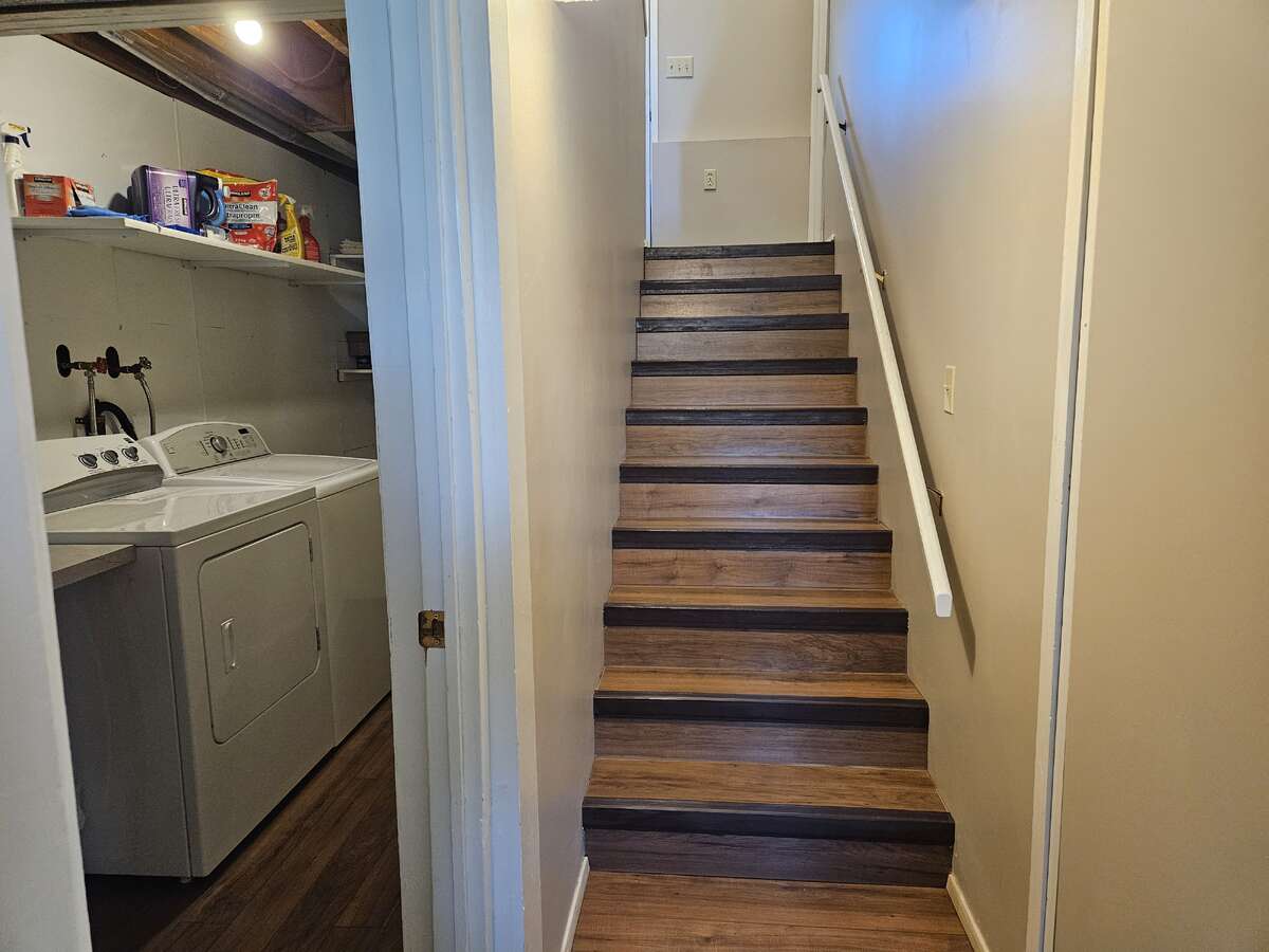 stairs to back door, laundry room and cold storage to the left