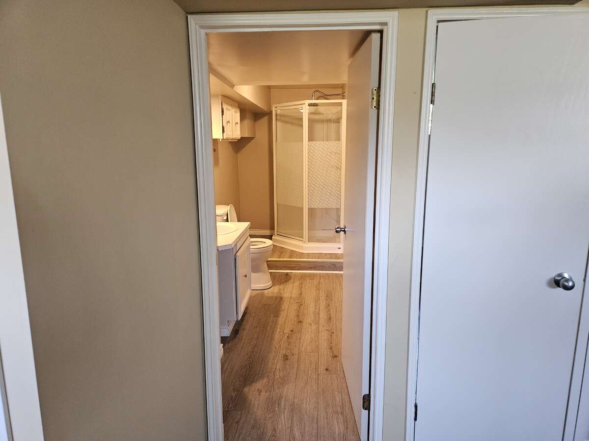 3 piece bottom bathroom looks toward back of house