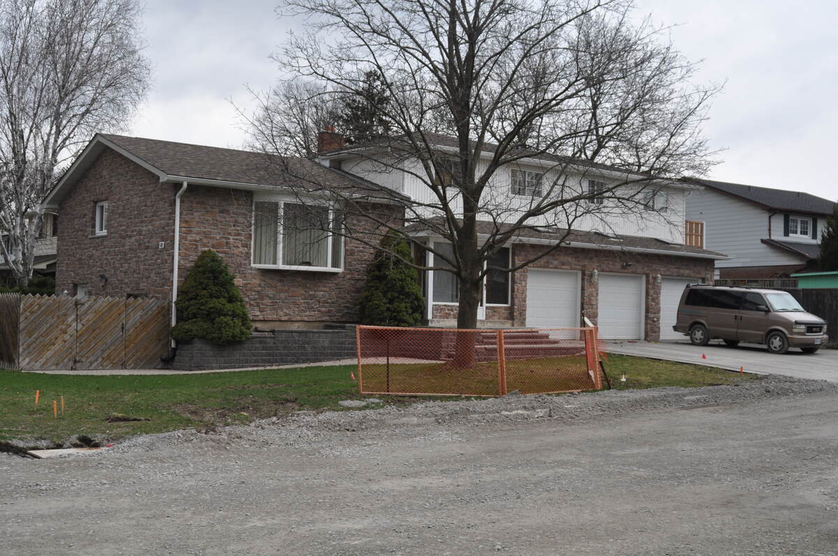 Three car garage, full size interior 30'Lx20'Wx10'H, w/3 skylights; stone veneer on brick and vinyl siding; new roof, new  vinyl soffit, fascia, aluminium eaves trough; new garage doors
